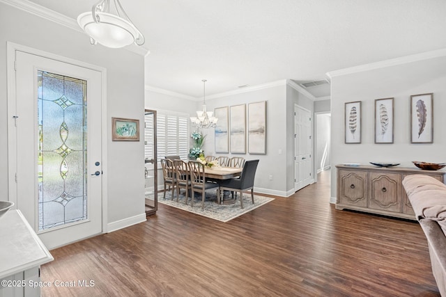 dining area featuring ornamental molding, dark hardwood / wood-style floors, and a notable chandelier