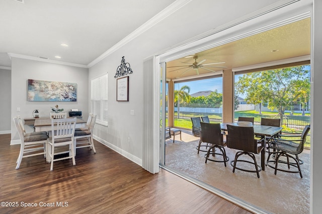 dining area with dark hardwood / wood-style flooring, ceiling fan, and crown molding