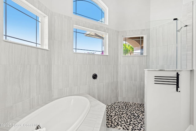 bathroom featuring separate shower and tub