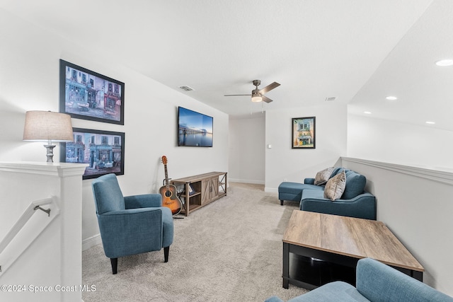 living room featuring light carpet and ceiling fan