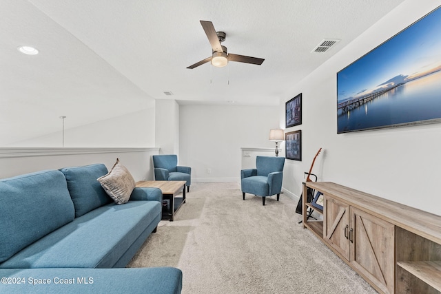 living room with light carpet, a textured ceiling, ceiling fan, and lofted ceiling