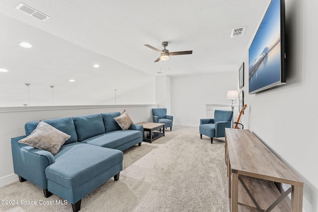 carpeted living room with ceiling fan, lofted ceiling, and a textured ceiling