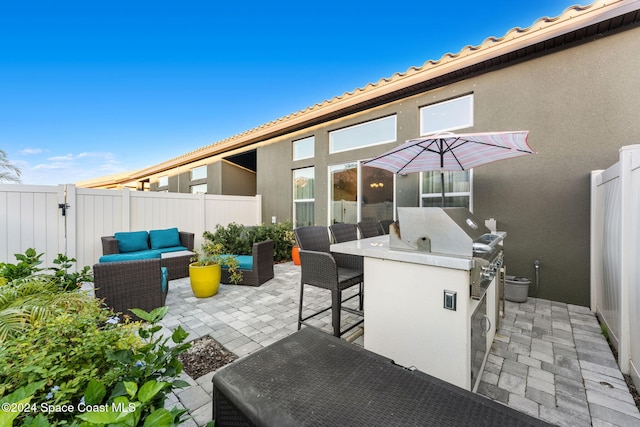 view of patio with an outdoor kitchen, a bar, and an outdoor hangout area