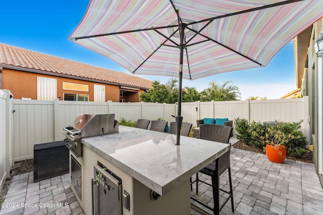 view of patio / terrace featuring area for grilling and a grill