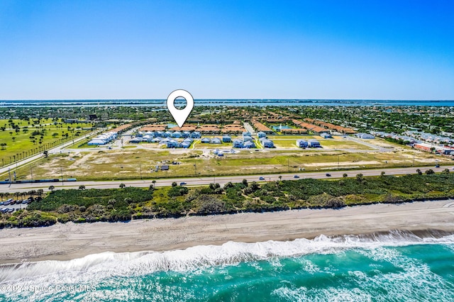 aerial view featuring a water view and a view of the beach