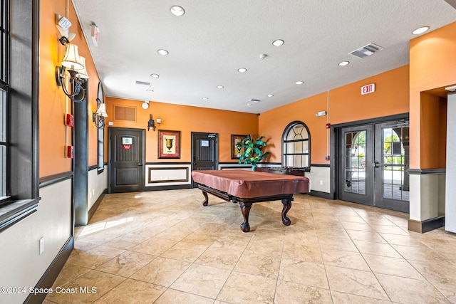 rec room featuring french doors, a textured ceiling, and billiards