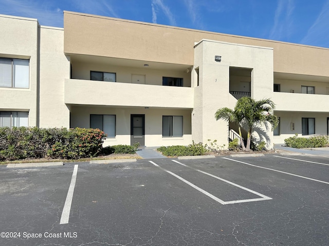 view of property with uncovered parking