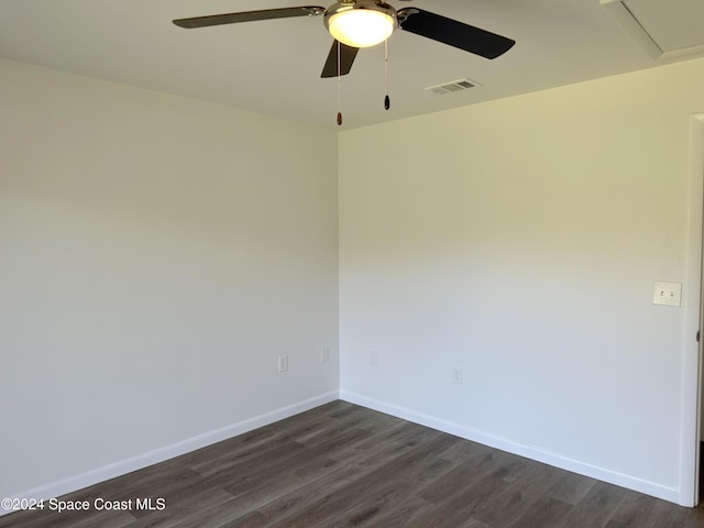 empty room with dark hardwood / wood-style flooring and ceiling fan