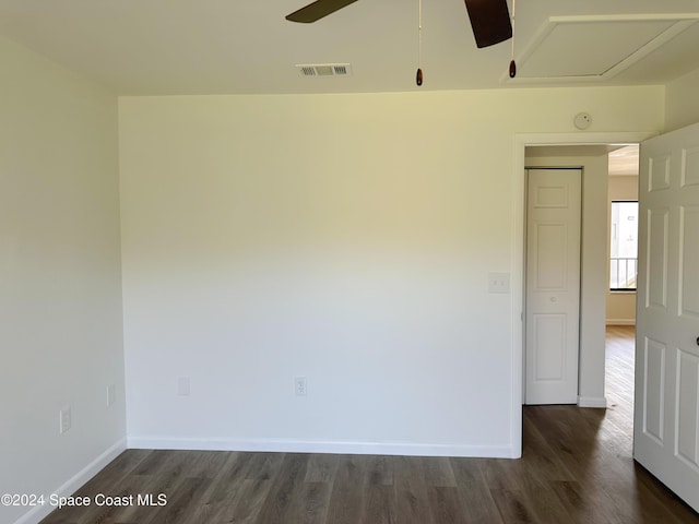 unfurnished room with ceiling fan and dark wood-type flooring