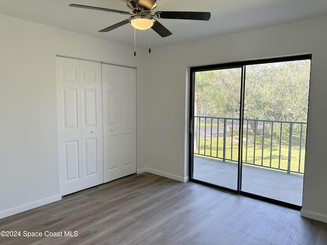 unfurnished bedroom with hardwood / wood-style floors, ceiling fan, access to exterior, and a closet