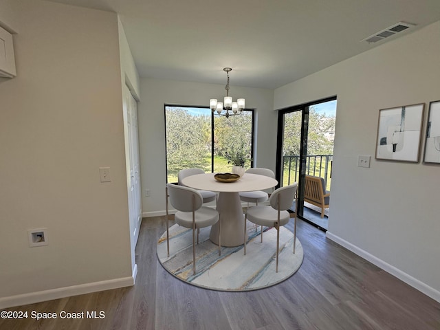 dining room with a chandelier and wood-type flooring