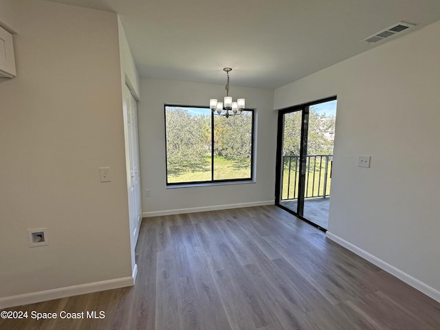 200 International Dr Unit 309, Cape Canaveral, FL 32920 - unfurnished dining area featuring a chandelier and wood finished floors