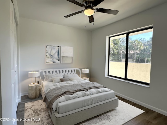 bedroom featuring ceiling fan and dark wood-type flooring