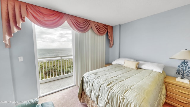 bedroom with access to outside, carpet flooring, and a water view