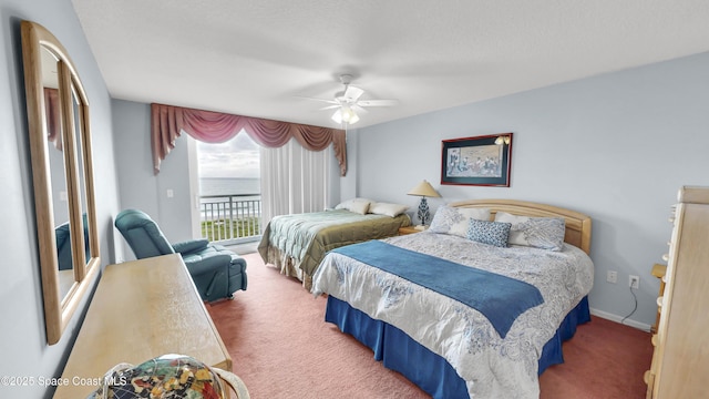 carpeted bedroom featuring ceiling fan, access to outside, and a water view