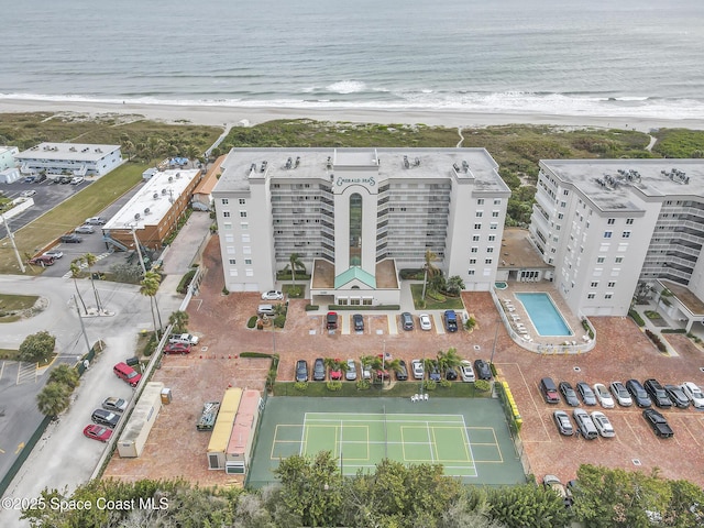 birds eye view of property featuring a beach view and a water view