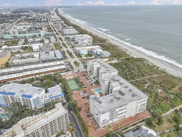 drone / aerial view with a beach view and a water view