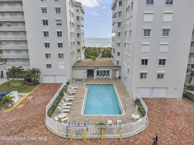 view of swimming pool with a water view