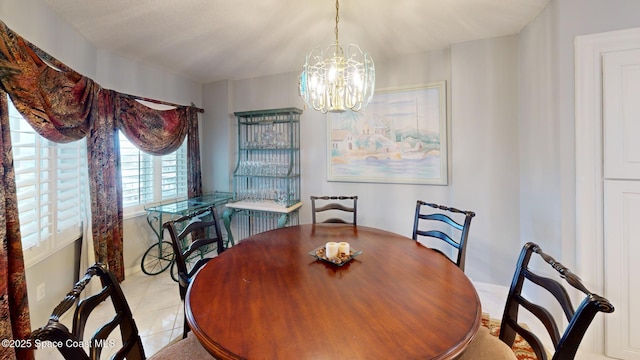 tiled dining room with a chandelier