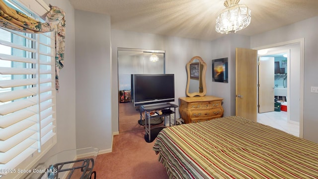 carpeted bedroom featuring a closet, a textured ceiling, and a notable chandelier