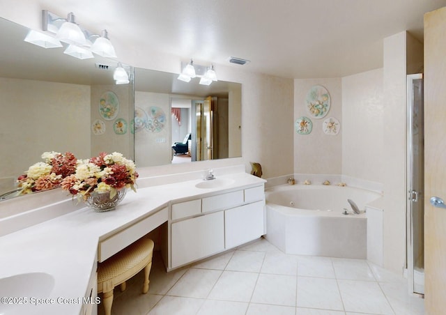 bathroom with vanity, tile patterned flooring, and a bathing tub