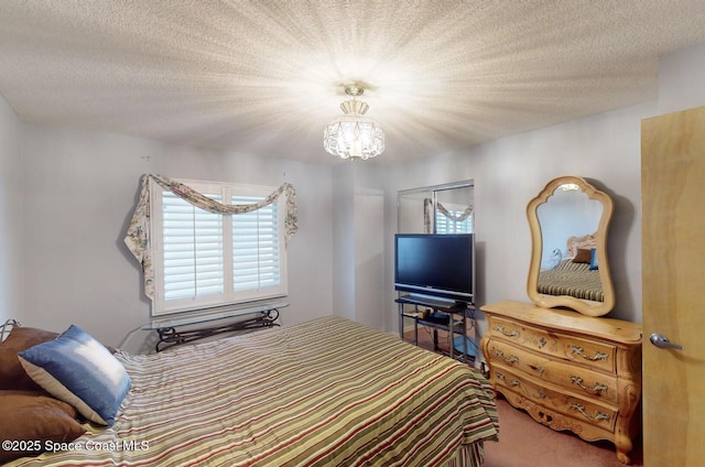 bedroom with a textured ceiling and an inviting chandelier