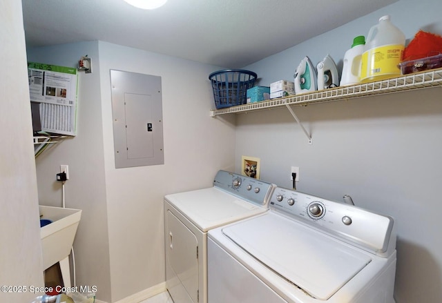 laundry area with electric panel and separate washer and dryer