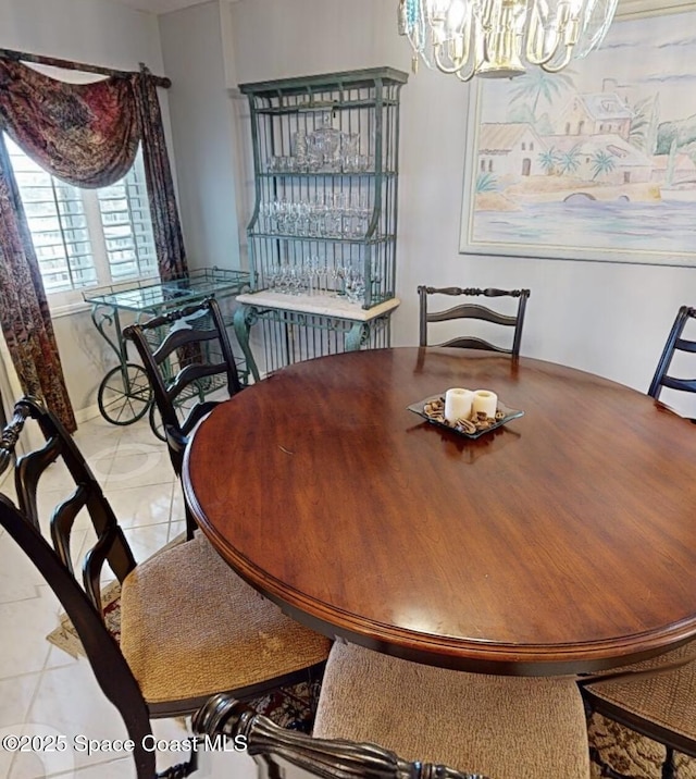 tiled dining space featuring a chandelier