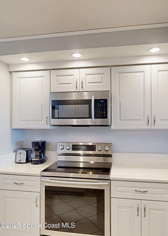 kitchen with stainless steel appliances and white cabinets