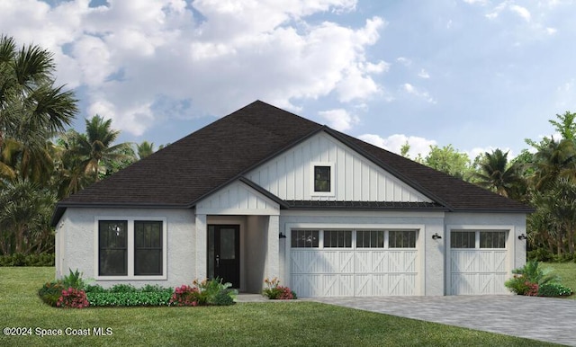 view of front of property featuring a front lawn and a garage