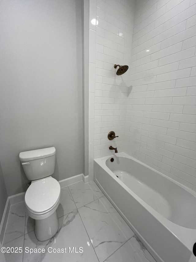 bathroom with toilet and bathing tub / shower combination