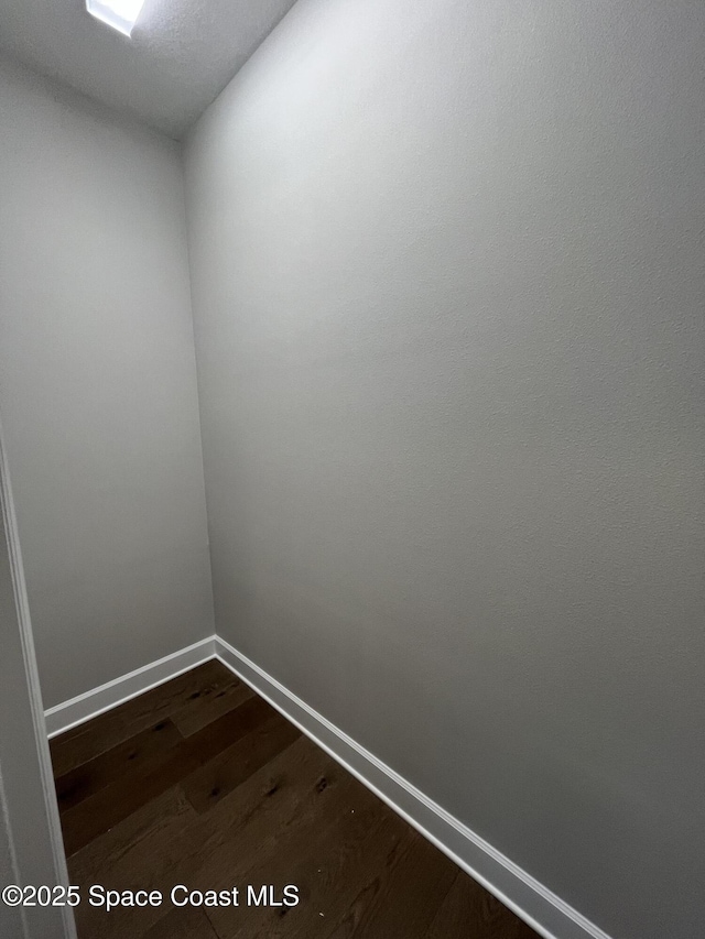 spare room featuring dark wood-type flooring