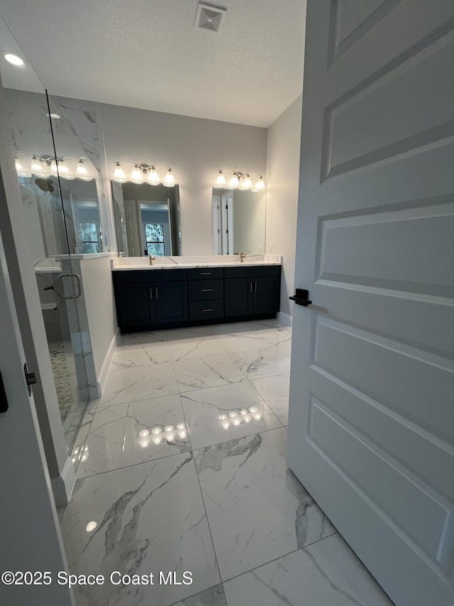 bathroom with an enclosed shower and vanity