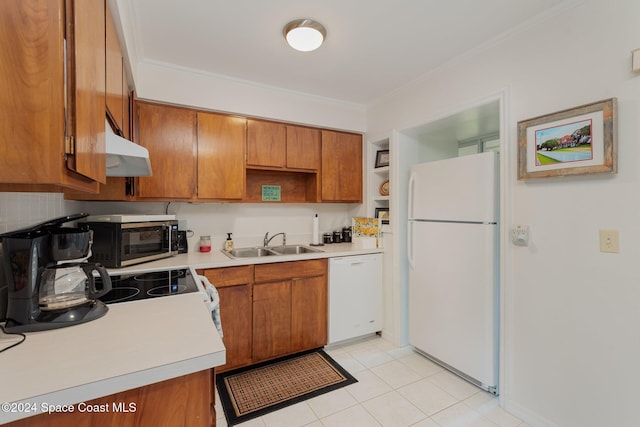 kitchen with white appliances, sink, light tile patterned floors, and ornamental molding