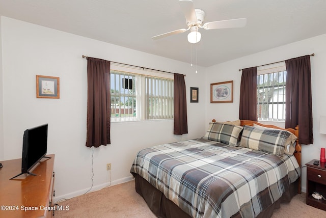 bedroom featuring ceiling fan and light carpet