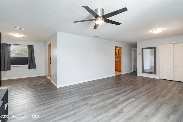 unfurnished living room featuring a textured ceiling, ceiling fan, and wood-type flooring