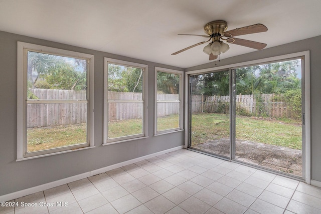 unfurnished sunroom with ceiling fan