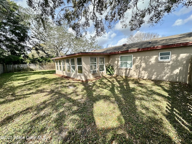 back of house with a lawn