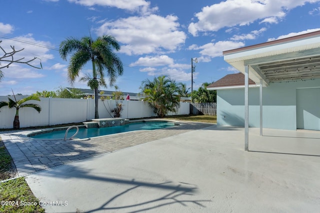 view of swimming pool with a jacuzzi and a patio area