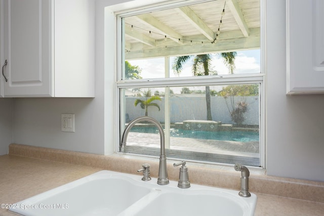 room details featuring white cabinetry and sink