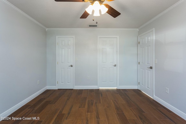 unfurnished bedroom featuring ceiling fan, crown molding, and dark wood-type flooring