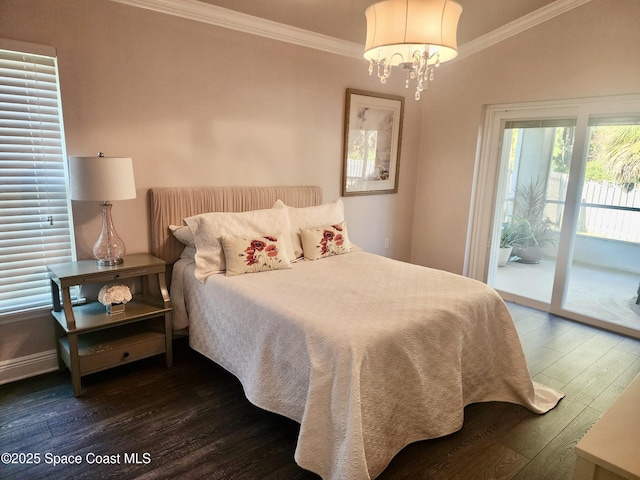 bedroom featuring dark hardwood / wood-style flooring, ornamental molding, access to outside, a chandelier, and lofted ceiling