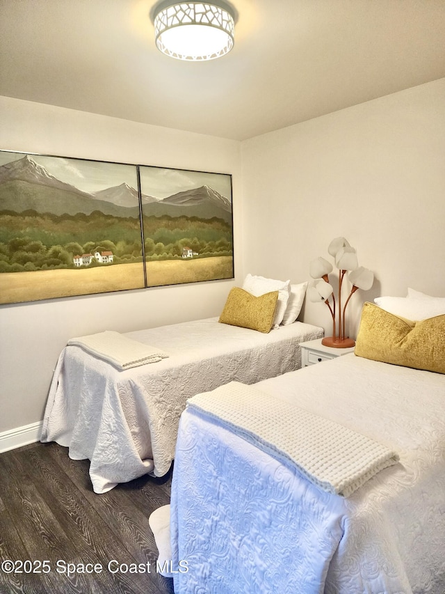 bedroom with dark hardwood / wood-style floors