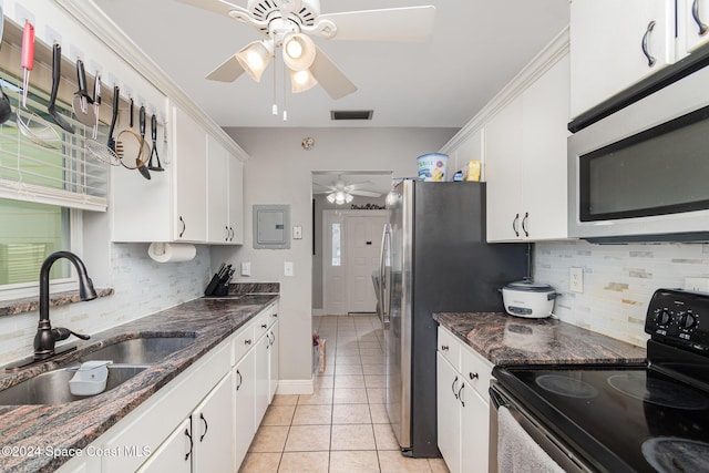 kitchen featuring backsplash, black / electric stove, white cabinetry, and sink