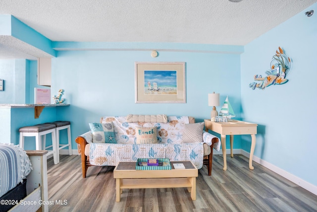 living room with hardwood / wood-style floors and a textured ceiling