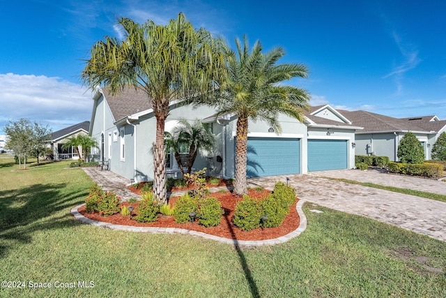 view of front of property featuring a front lawn and a garage