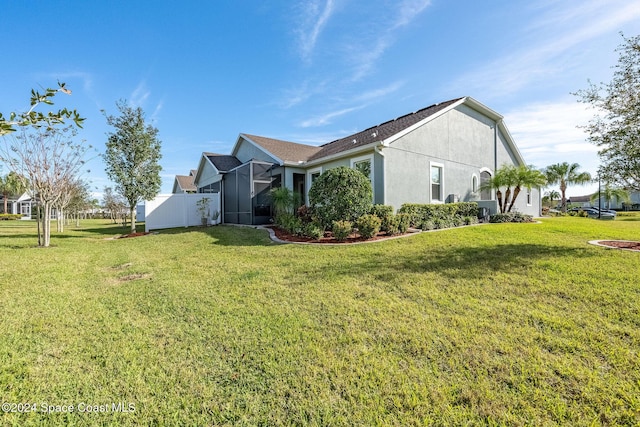 view of side of property featuring a yard