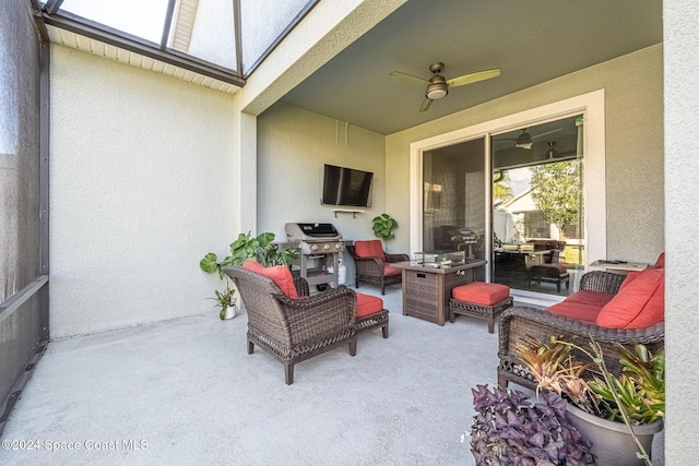 view of patio featuring a grill, ceiling fan, and an outdoor living space