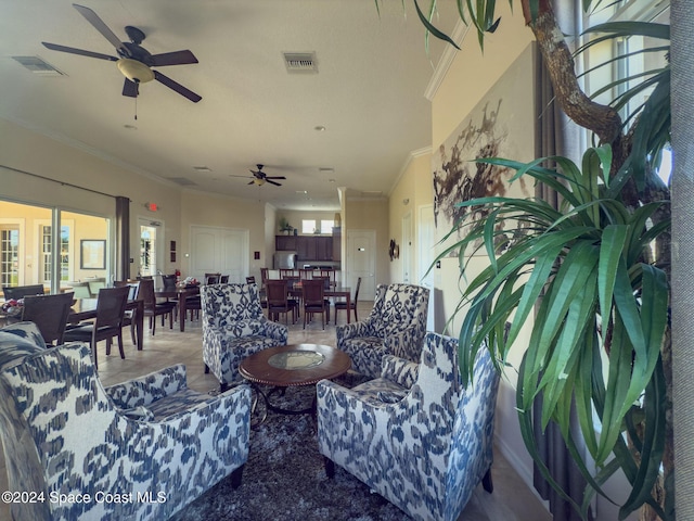 living room with ceiling fan, crown molding, and light tile patterned flooring