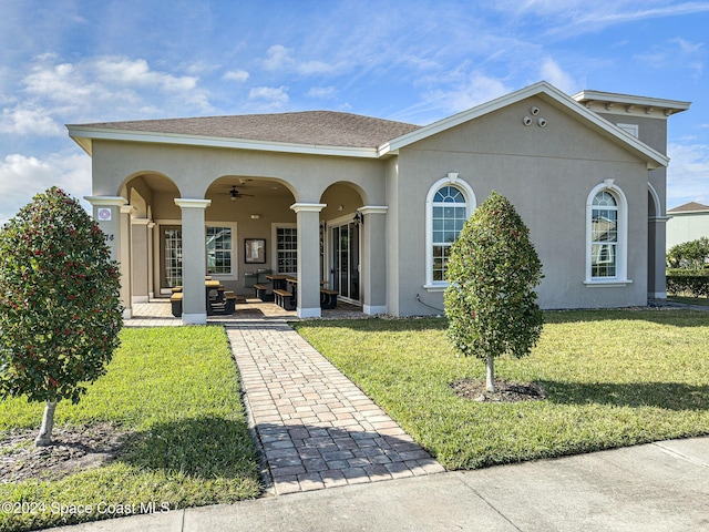 rear view of house featuring a lawn, ceiling fan, and an outdoor living space